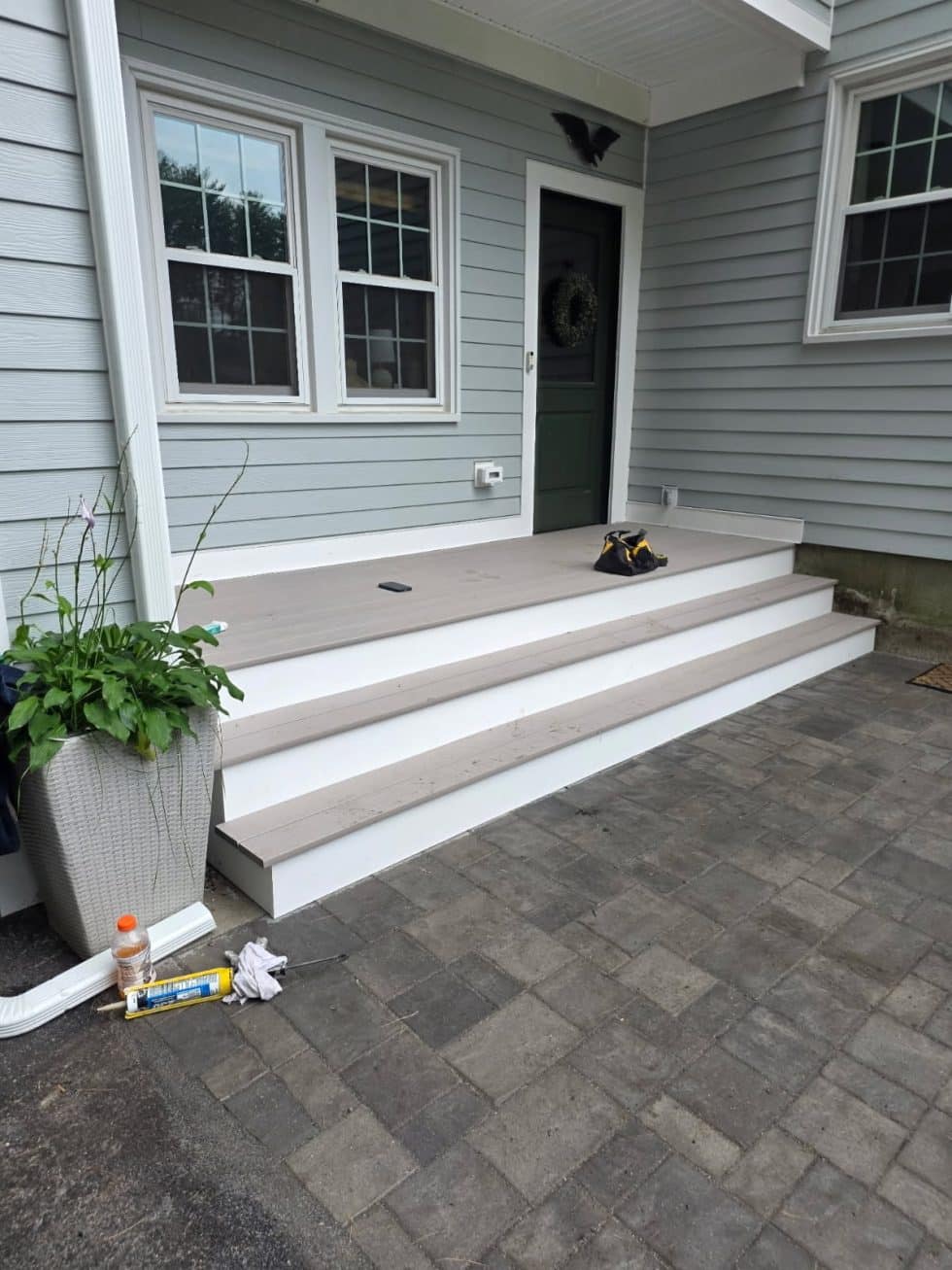 Composite front entry steps and full-width platform between a house and garage in Andover, MA