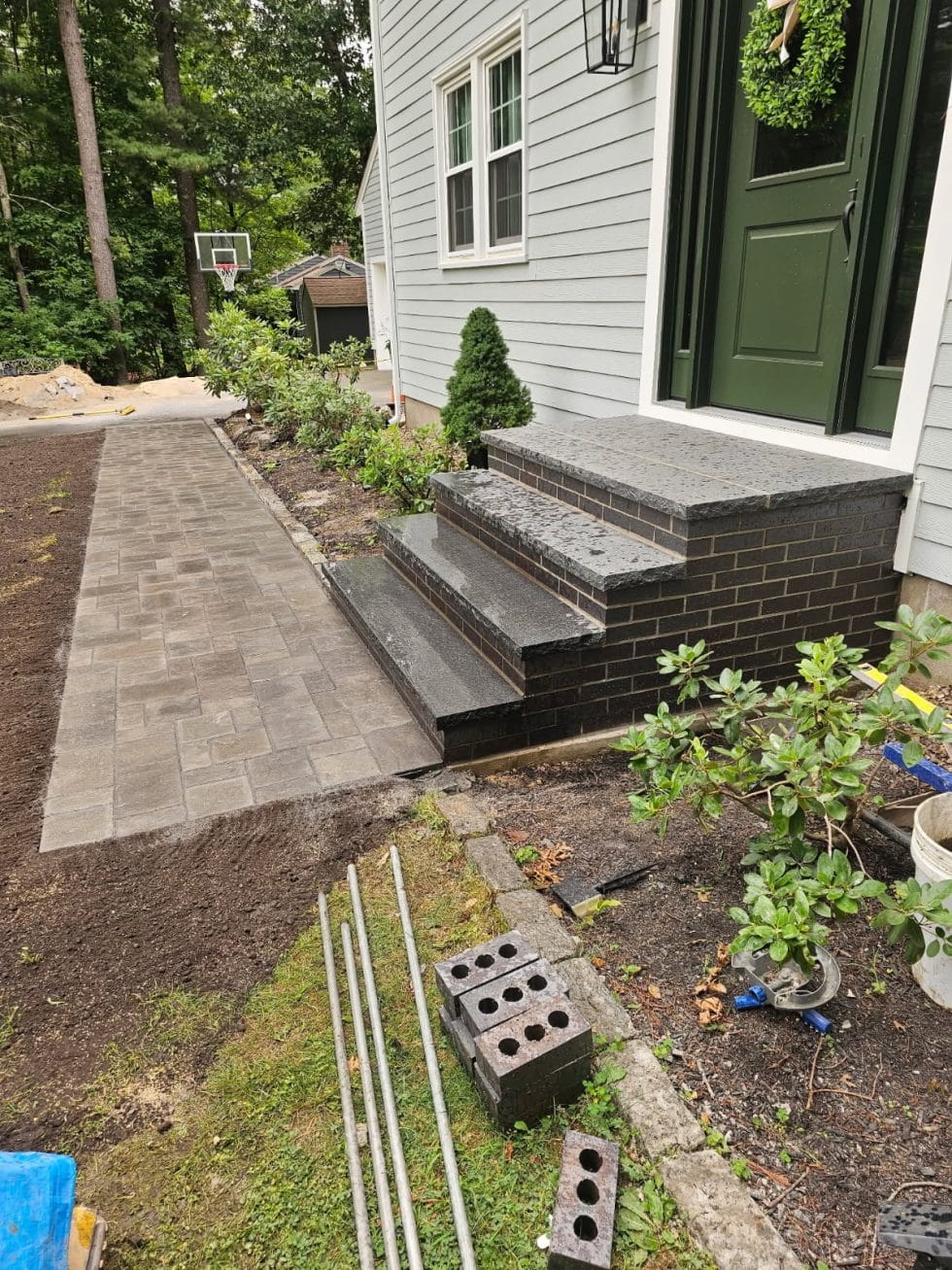New dark brick and granite front steps with a paver walkway in Andover, MA